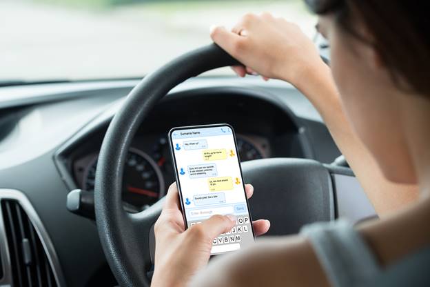 A person using a phone while driving
AI-generated content may be incorrect.